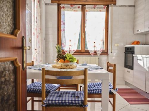 a kitchen with a table with a bowl of fruit on it at Casa Gianchi, a full immersion in nature in Pallanzeno