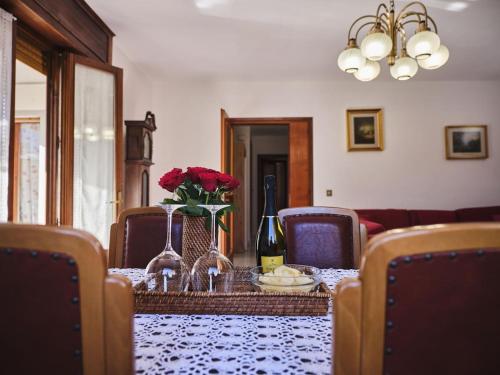 a dining room table with a table cloth with flowers on it at Casa Gianchi, a full immersion in nature in Pallanzeno