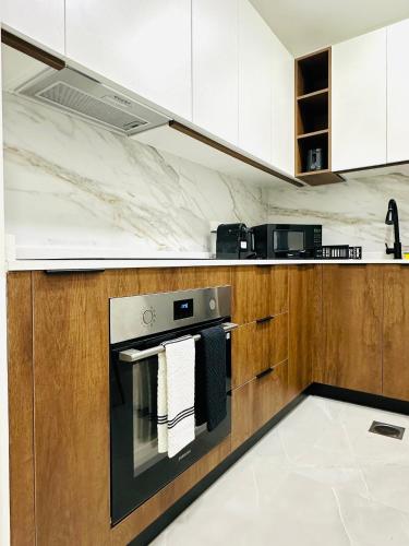 a kitchen with a stove with towels on the oven at Lake City Tower in Dubai