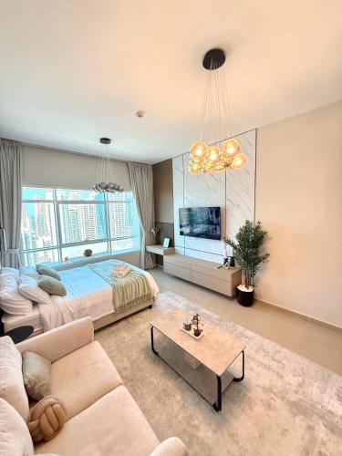 a large bedroom with a bed and a couch at Lake City Tower in Dubai