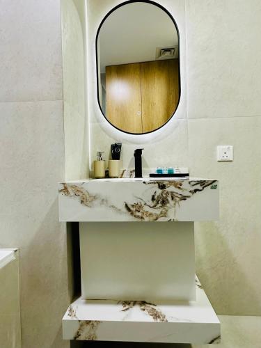 a bathroom with a sink and a mirror at Lake City Tower in Dubai