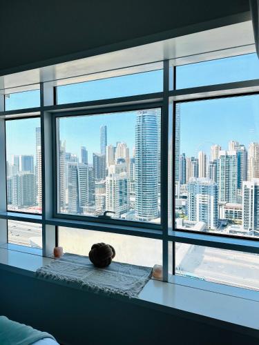 a window with a view of a city skyline at Lake City Tower in Dubai
