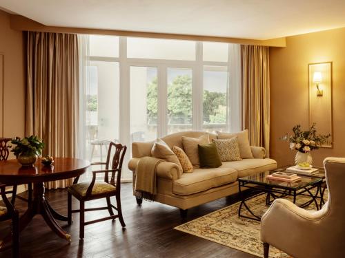 a living room with a couch and a table at Corinthia Palace Malta in Attard
