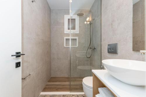 a bathroom with a shower and a sink at Villa Angelo in Paleokastritsa