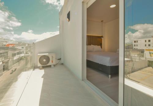 a bedroom with a bed on a balcony at Hotel Blu Sai in San Andrés