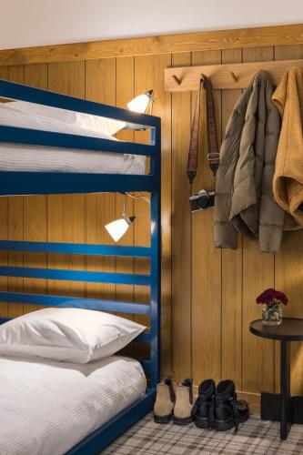 a bedroom with a blue bunk bed and some shoes at The Virginian Lodge in Jackson