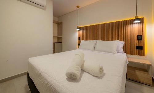 a bedroom with a white bed with a towel on it at Hotel Blu Sai in San Andrés