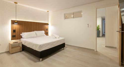 a bedroom with a bed and a large mirror at Hotel Blu Sai in San Andrés