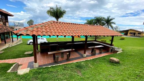 a pavilion with a bench and a roof at Finca Quinta el chalet in Calima