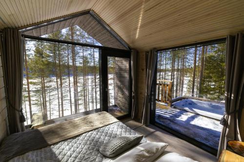 an inside view of a room with a bed and windows at Hossaville Luxe West Lake Cabin in Hossa
