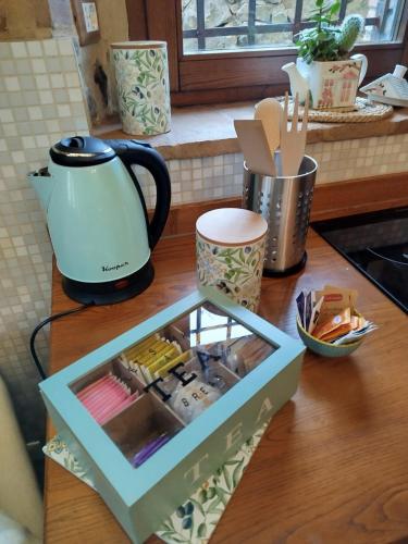 a counter top with a tea kettle and a box on it at L' antico lavatoio in Radicofani