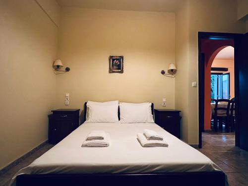 a bedroom with a bed with two towels on it at Panthoron Tzoumerka in Vourgareli