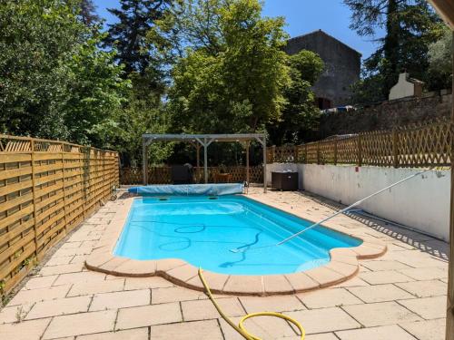 a swimming pool in a backyard with a fence at Grande maison proche Carcassonne 10 p piscine spa sauna Le Grand Chalet Bellevue in Cavanac