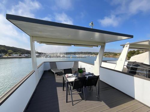 a deck of a boat with a table and chairs at Floating House - LUXURY Floating Sea OASIS Pula in Pula