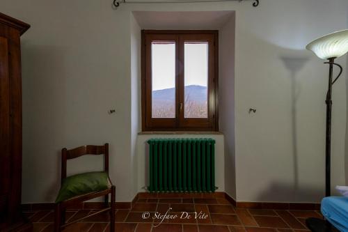 a room with a window and a green radiator at Il Borgo Del Lupo Relax Family Apartments in Tuscany with Restaurant & Swimming Pool in Sarteano