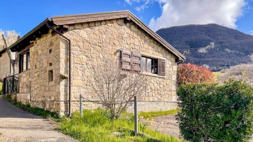 a stone building with a window on the side of it at Sole's House in Verzuno