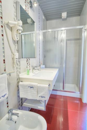 a bathroom with a white sink and a shower at Albergo Diffuso - Il Poggetto tra Urbino & San Marino in Urbino