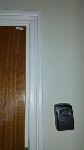 a door with a clock on the wall next to a window at Noah Longstay Nygatan 36 in Skellefteå