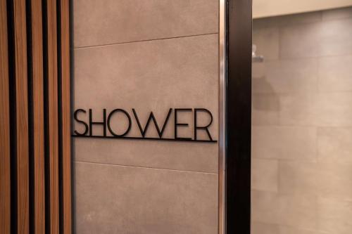 a door with the word shower written on it at Radisson Blu Hotel at Porsche Design Tower Stuttgart in Stuttgart