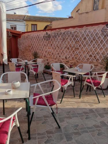 a group of tables and chairs on a patio at Casa Rural La Palmera in Cañada del Trigo