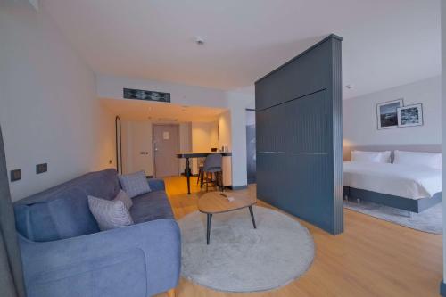 a living room with a couch and a bed at Radisson Hotel Mersin in Mersin