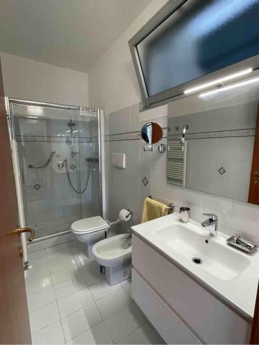 a bathroom with a sink and a toilet and a shower at Casa Pineta in Diano Marina