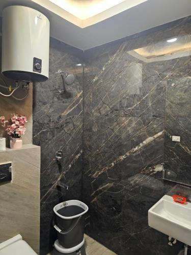 a bathroom with a toilet and a sink at Ultra Luxury Cool Flat By Bliss Stay in Ghaggar