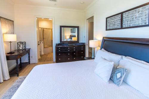 a bedroom with a bed and a desk and a mirror at Journeys End 101 in Coffeyville