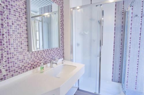 a white bathroom with a sink and a shower at Albergo Diffuso - Il Poggetto tra Urbino & San Marino in Urbino