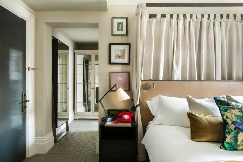 a hotel room with a bed and a window at Kimpton Fitzroy London by IHG in London