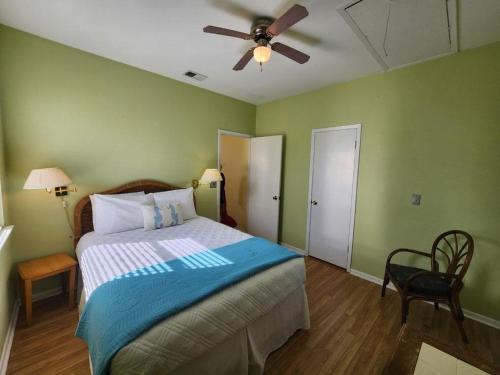 a bedroom with a bed and a ceiling fan at Blue Haven in Coffeyville