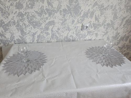 a bed with two wine glasses on top of it at 1 ком 11 мкр возле керуен сити , Аквапарк in Aktobe