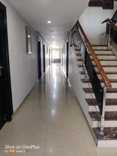 an empty hallway with stairs in a building at Hotel Delphi Grand Hyderabad - Hi-Tech City, Perfect for Business & Comfort in Hyderabad