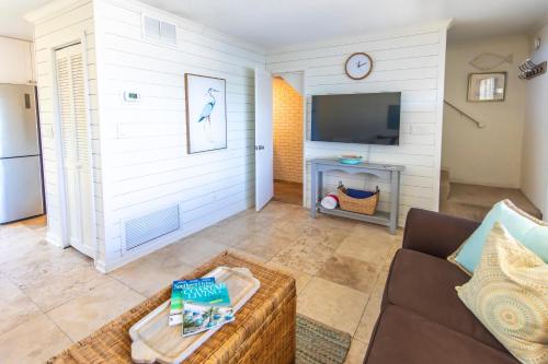 a living room with a couch and a tv at Whispering Sands 1A in Coffeyville