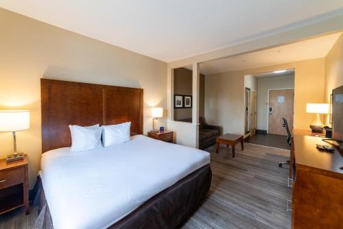 a hotel room with a large bed and a desk at Sonesta Essential - Baton Rouge Airport in Baton Rouge