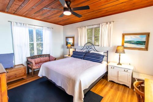 a bedroom with a bed and a ceiling fan at Blue in Santa Rosa Beach