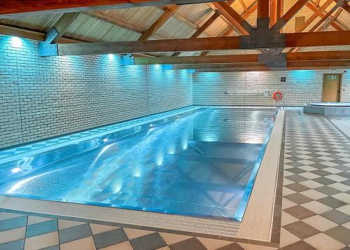 a large swimming pool in a building at Woodland Lakes Boutique Lodges in Aughton