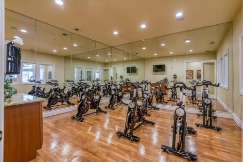 a gym with a lot of treadmills and ellipticals at New Cozy 1BR Apt with Gym Sauna & Heated Pool Access in Reno