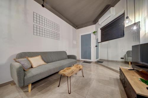 a living room with a couch and a table at New Maisonette in the Centre of Naxxar in Il-Ħamrija