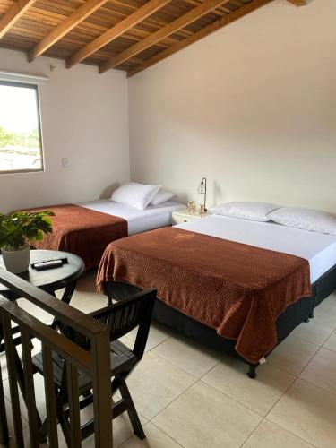 una camera con due letti e un tavolo con una sedia di Hermoso Aparta-Estudio En Envigado cerca de Medellin a Envigado