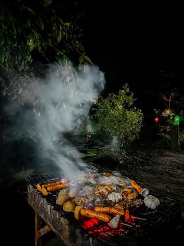 a grill with lots of meat and vegetables on it at Eco Lodge Meemure & Adventure Park in Meemure