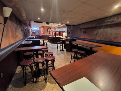 a restaurant with wooden tables and bar stools at Smart Resorts B&B 1 BB1 215 in Winterberg