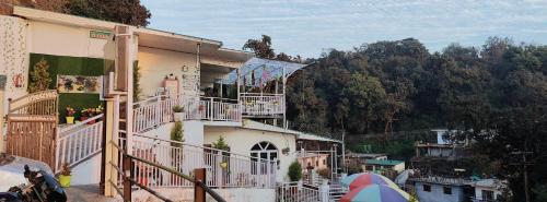 a balcony of a building with a tent next to it at Golden Oak Villa Mussoorie in Rājpur