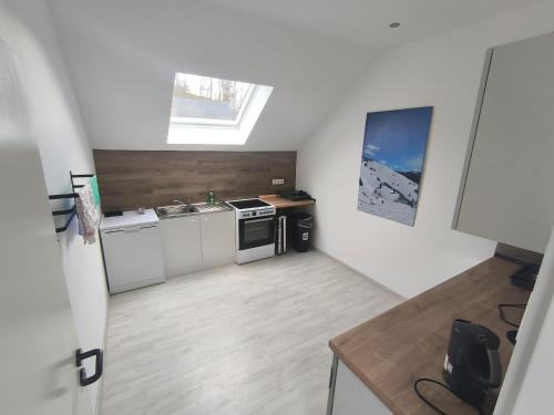 a kitchen with white cabinets and a sink and a window at Smart Resorts B&B 2 BB2 326 in Winterberg