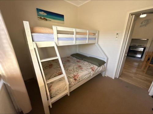 a couple of bunk beds in a room at Blue Line Retreat - Unit 1 in Port Vincent