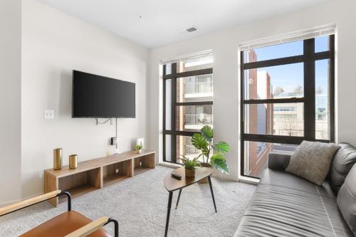 a living room with a couch and a flat screen tv at The Leisure & The Work Mixed In One-Site in Arlington