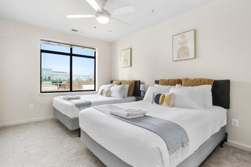 two beds in a room with a window at The Leisure & The Work Mixed In One-Site in Arlington