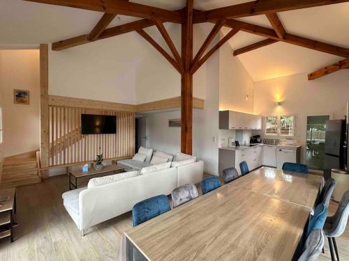 a living room with a white couch and a table at Villa Sur La Dune Moliets, 12 people, beach, golf in Moliets-et-Maa