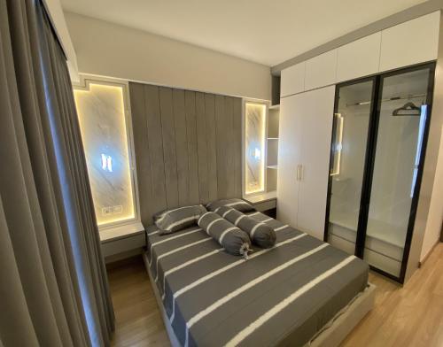a bedroom with a bed with two pillows on it at Sky House BSD in Samporo