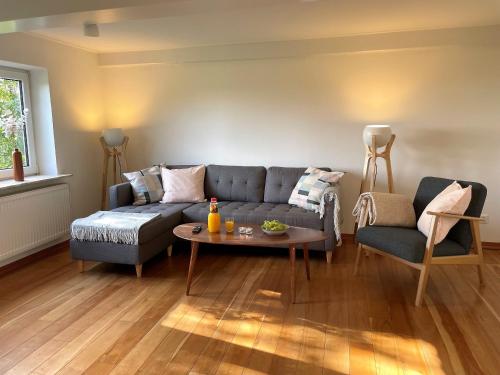 a living room with a couch and a table at Ferienhaus Nordwind 1849 Dagebüll in Fahretoft